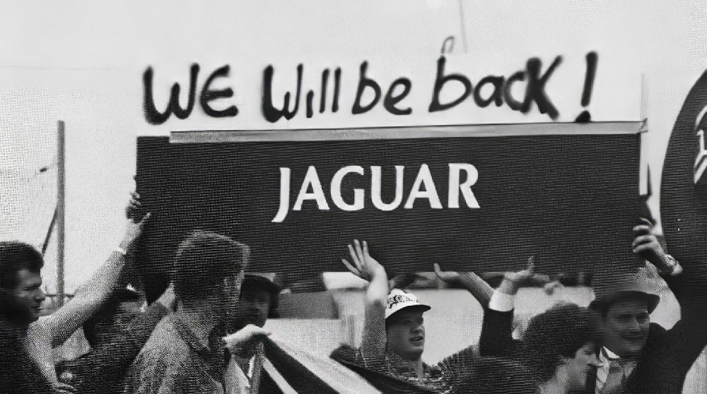 Fans carrying the We Will Be Back Jaguar banner