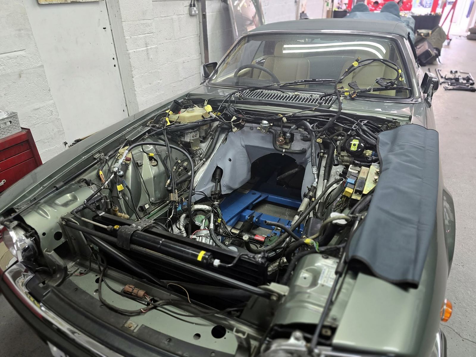 A stripped engine bay under restoration