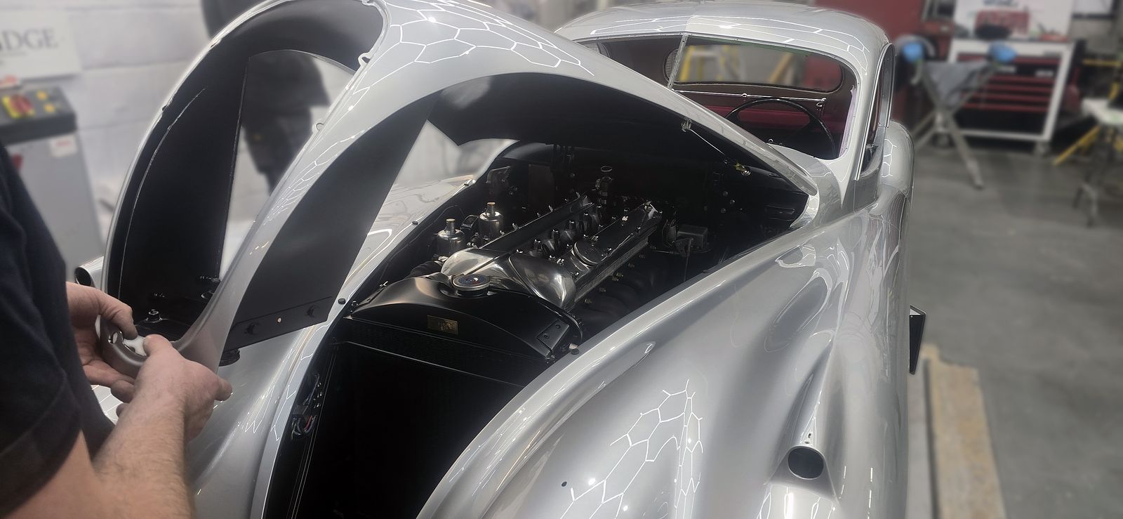 Bonnet up over the engine bay as re-assembly begins