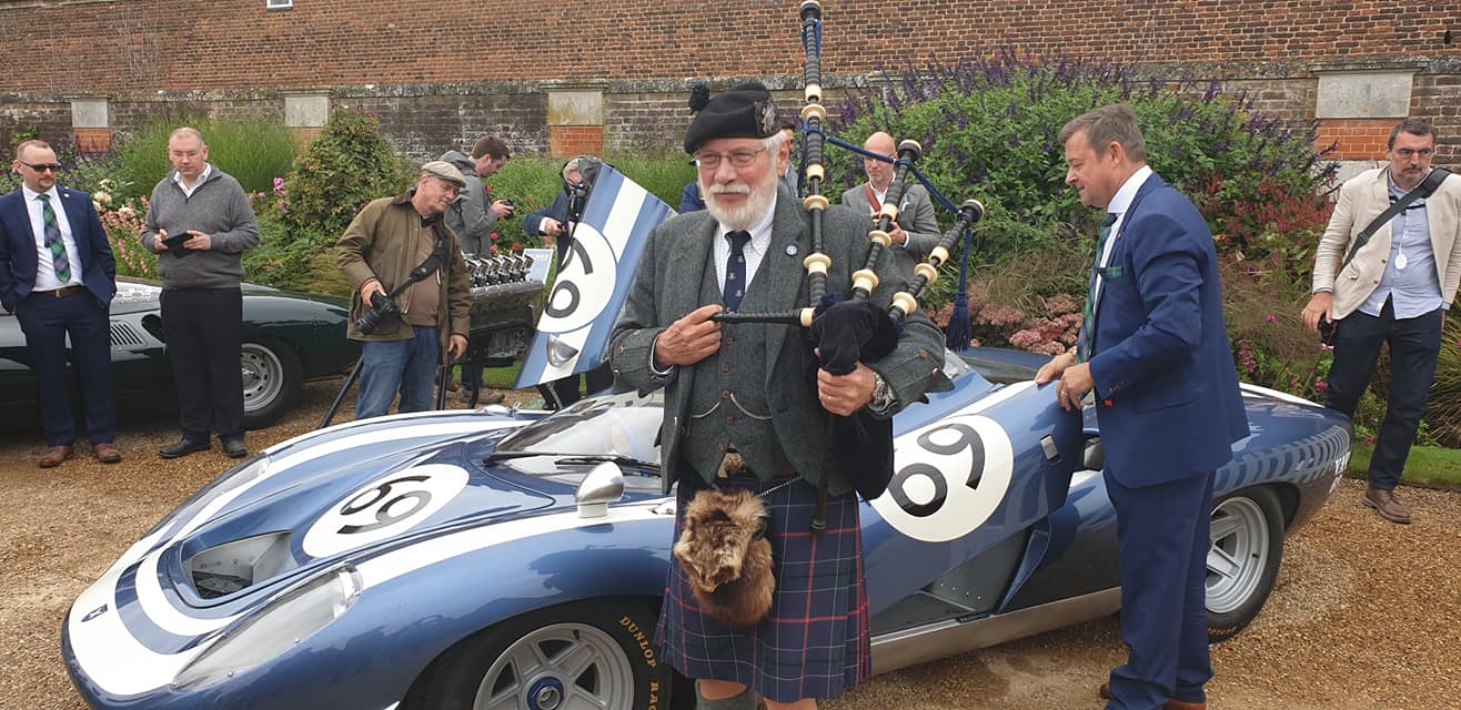 A bagpiper performing beside the LM69