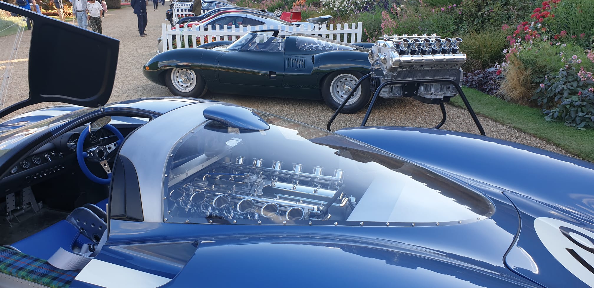 The LM69 engine bay open with a period stablemate behind