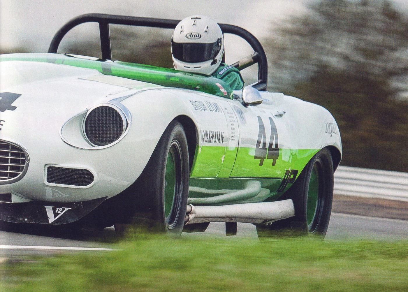 Group 44’s E-type at speed in its white-over-green Quaker State livery