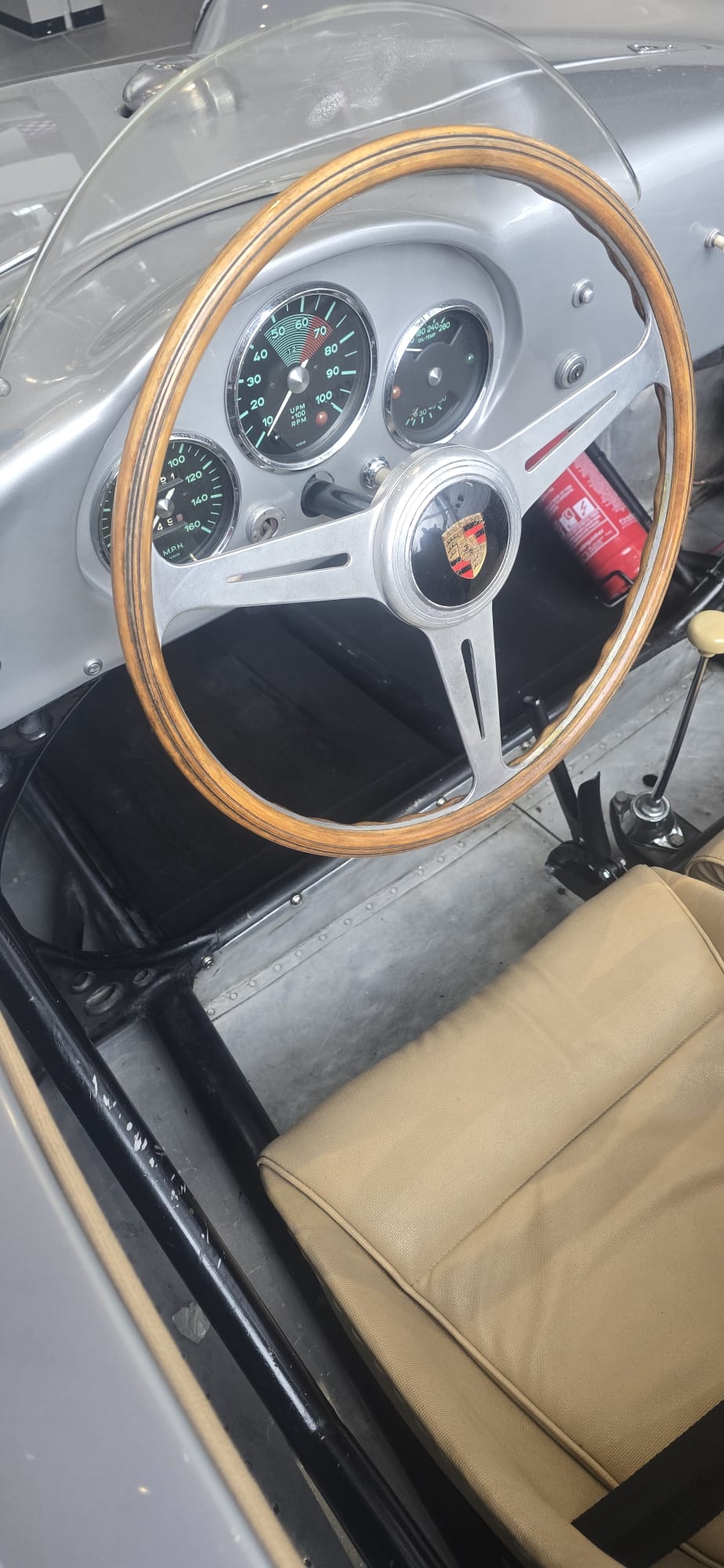 Wood-rimmed steering wheel, dashboard gauges and fire extinguisher